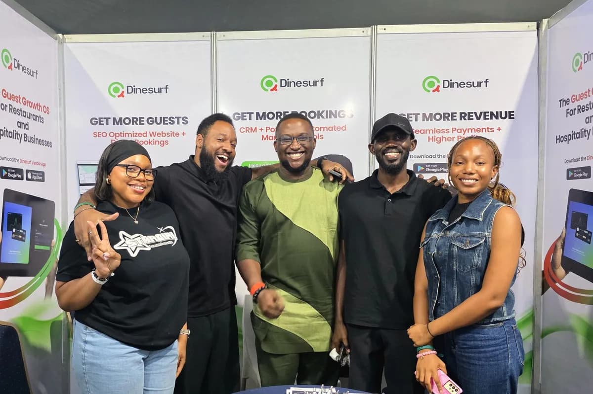 The Dinesurf team in front of the Dinesurf stand at Nigeria Food Summit 2026, under banners reading Get more guests, Get more bookings and Get more revenue.